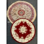Rugs - a circular floral rug central medallions in tones of red, blue, cream within similar cream