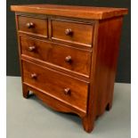 A miniature mahogany chest of drawers, over sailing top above two short over two long graduated