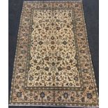 A fine Persian Kashan rug / carpet, woven with a dense field of stylised floral motifs, in shades of