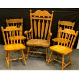 A 20th century pine rocking chair, slightly outswept arms, 118cm high; a pair of pine dining side