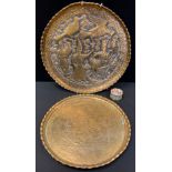 A Persian circular brass tray, embossed with stylised figures and birds, 44cm diam; another,