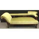 A Victorian mahogany chaise lounge, upholstered in green, carved gallery, turned legs, 66cm high,