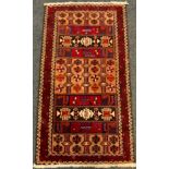 A hand-knotted Persian Balouch (Baluch) rug / carpet, woven with stylised geometric motifs in shades