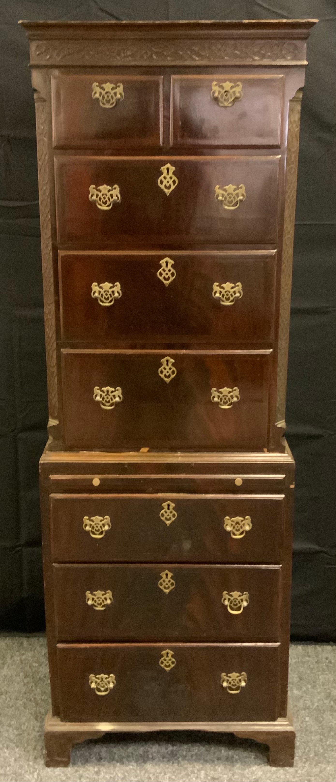 A reproduction mahogany chest on chest of narrow proportions, slightly outswept cornice above two