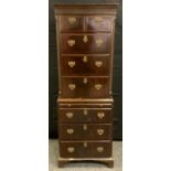 A reproduction mahogany chest on chest of narrow proportions, slightly outswept cornice above two