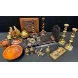 A Victorian brass and ebonised book slide, c.1870; a pair of turned oak candlesticks; a pair of 19th