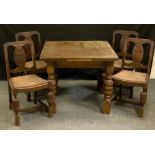 A 20th century oak draw-leaf table; a set of four 20th century oak dining chairs, carved splat,