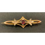 An Edwardian seed pearl and garnet bar brooch, open crest, yellow metal frame, tests as 9ct gold,