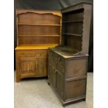 A Boulds Cabinet makers of Stoke en Trent light oak dresser, two shelf plate rack back above deep