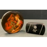 A 19th century circular lacquered papier mache painted snuff box, lid painted with figures