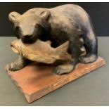 A large 'Black Forest' Brown Bear, with salmon in his mouth, rectangular base, 38cm wide