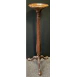 A Victorian style mahogany torchere stand, tapering fluted column, carved tripod ball and claw feet,