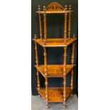 A Victorian inlaid walnut four tier whatnot, arched pierced crest, four canted rectangular