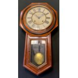 An Ansonia Clock Company mahogany wall clock, white face, black Roman numerals, twin winding