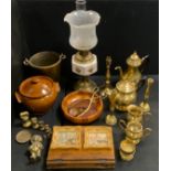 A brass and ceramic oil lamp; brass tea and coffee ware; ice bucket; oak music stand; 'Golly'