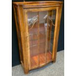 A mid 20th century slightly serpentine oak display cabinet, 118cm high, 69cm wide, c.1940