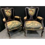 A pair of late Victorian ebonised salon elbow chairs, shield shaped splats, stuffed over seats, c.