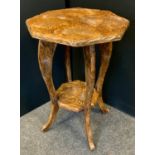 A hand carved Liberty style side table, octagonal top carved in the Japanese taste with blossoming