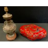 A Chinese Archaic bronze lamp base, 36cm high; a quatrefoil shaped red lacquered box and cover, 32cm