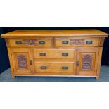 An early 20th century mahogany sideboard, fitted with two drawers above two field cupboard doors,