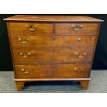 A George III oak chest, of two short and three long graduated cockbeaded drawers, swan neck handles,