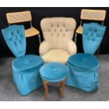 A pair of retro 1960s shield back chairs and conforming foot stool, upholstered in a vibrant blue