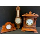 An Ansonia Clock Company oak mantel clock, c.1890; another, mahogany, c.1910; an oak barometer (3)