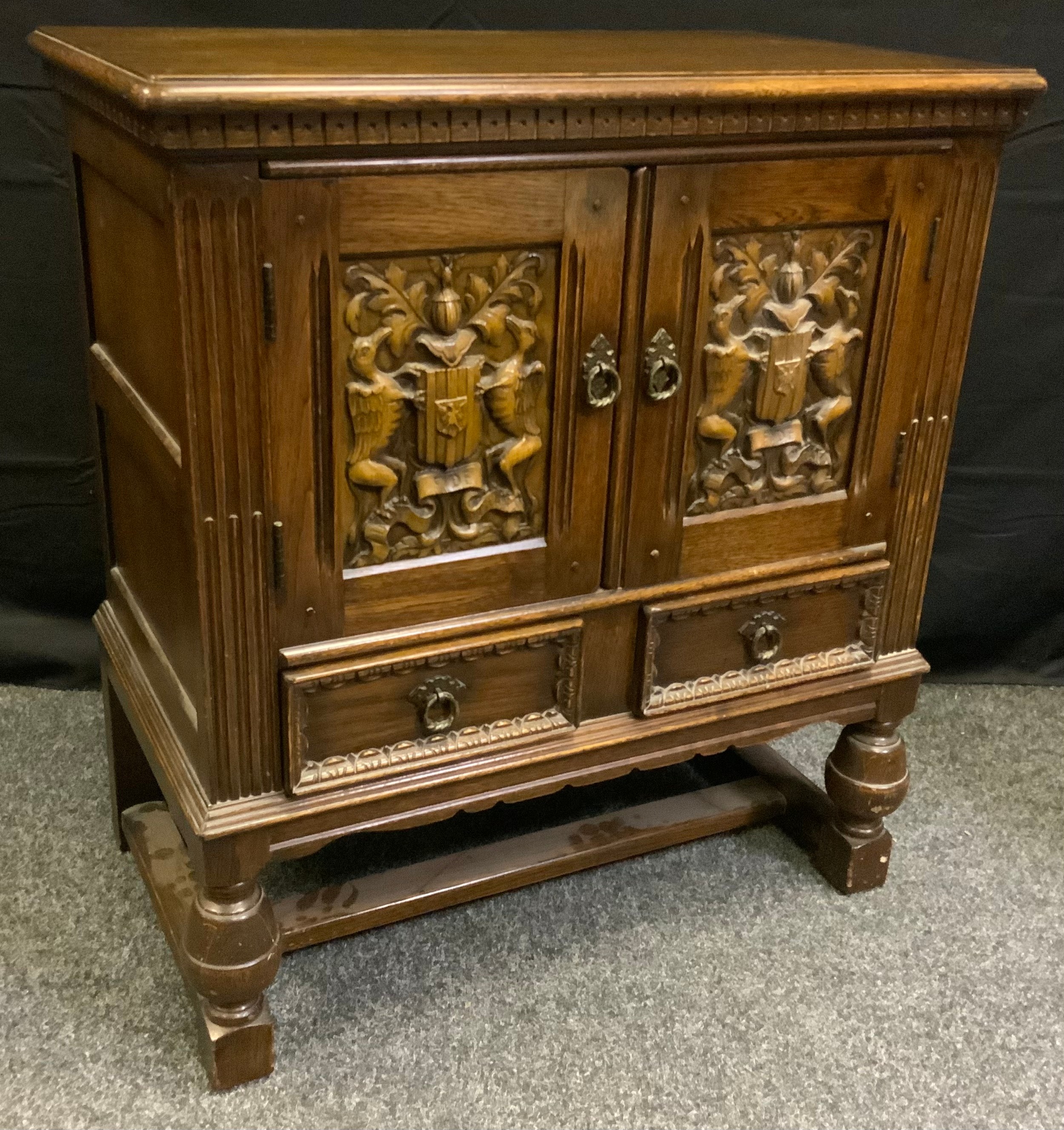 An oak Jacobean revival side cabinet, 84.5cm tall x 76.5cm wide x 43.5cm deep