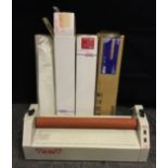 A 24 inch Hot press laminator by Tullis Russell, along with laminating sheet rolls.