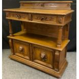 A Victorian Aesthetic movement oak Buffet, half-galleried over-sailing top with carved border, above