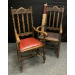 A pair of carved oak high back throne chairs, shaped rail carved with a crown, scrolling frame,