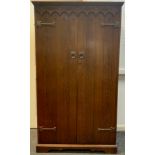 An oak bachelor's wardrobe, 167.5cm tall x 96cm wide x 48.5cm deep.