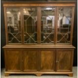 A Victorian style mahogany bookcase cabinet, two pairs of astral glazed doors to top enclosing three