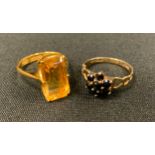 An oriental vibrant yellow citrine rectangular baguette cut dress ring, gold coloured metal shank,