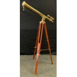 A 20th century brass telescope on a tripod base, (telescope measuring 96cm in length).