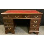 A mid 20th century mahogany pedestal desk, inset red leather top, one long and two short drawers