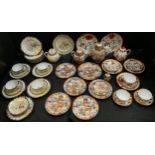 A Japanese eggshell porcelain part tea service intricately decorated with traditional birds and