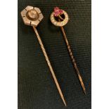 A late Victorian seed pearl and pinky red stone tie pin, stamped 9ct, 1.3g gross; another gold