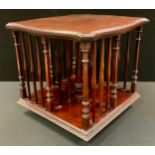A revolving shaped square table top book stand, ornate corner and principle columns, stepped wavy