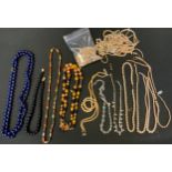 A single strand slightly graduated jet bead necklace, gold coloured clasp, 41cm; beep blue bead