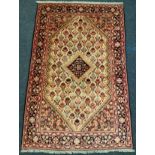 A fine Persian Bidjar wool and silk mix rug / carpet, woven in shades of red, dark brown and