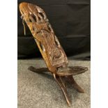 An early 20th century carved African / Kenyan birthing chair, 67cm tall.