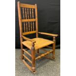 An early 20th century Country Rocking chair, wicker seat