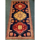 A Fine Persian Baidjar woollen rug / carpet, woven with three large medallions and stylized