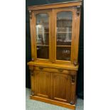 A Victorian mahogany bookcase cabinet, the pair of glazed doors to top enclosing two tiers of