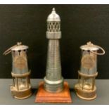 An Eccles Miners lamp; another; an Industrial Art Lighthouse table lamp (3)