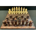 An Elizabethan style figural Chess set, King 12.7cm high, carved board