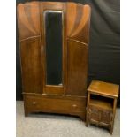 An Art Deco style oak wardrobe, central rectangular bevelled mirror above a long deep drawer,