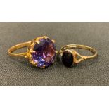 A 9ct gold onyx oval panel dress ring, size Q, 1.6g gross; a purply blue dress ring, yellow metal