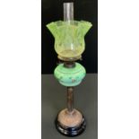 A Victorian oil lamp, floral painted opaque green glass reservoir, bulbous eight point fading